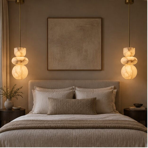 Pair of Alverra alabaster pendants beside a bed