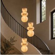 Three Alverra pendants descending through a stairwell