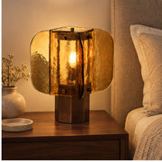 Amber glass lamp on a bedside table