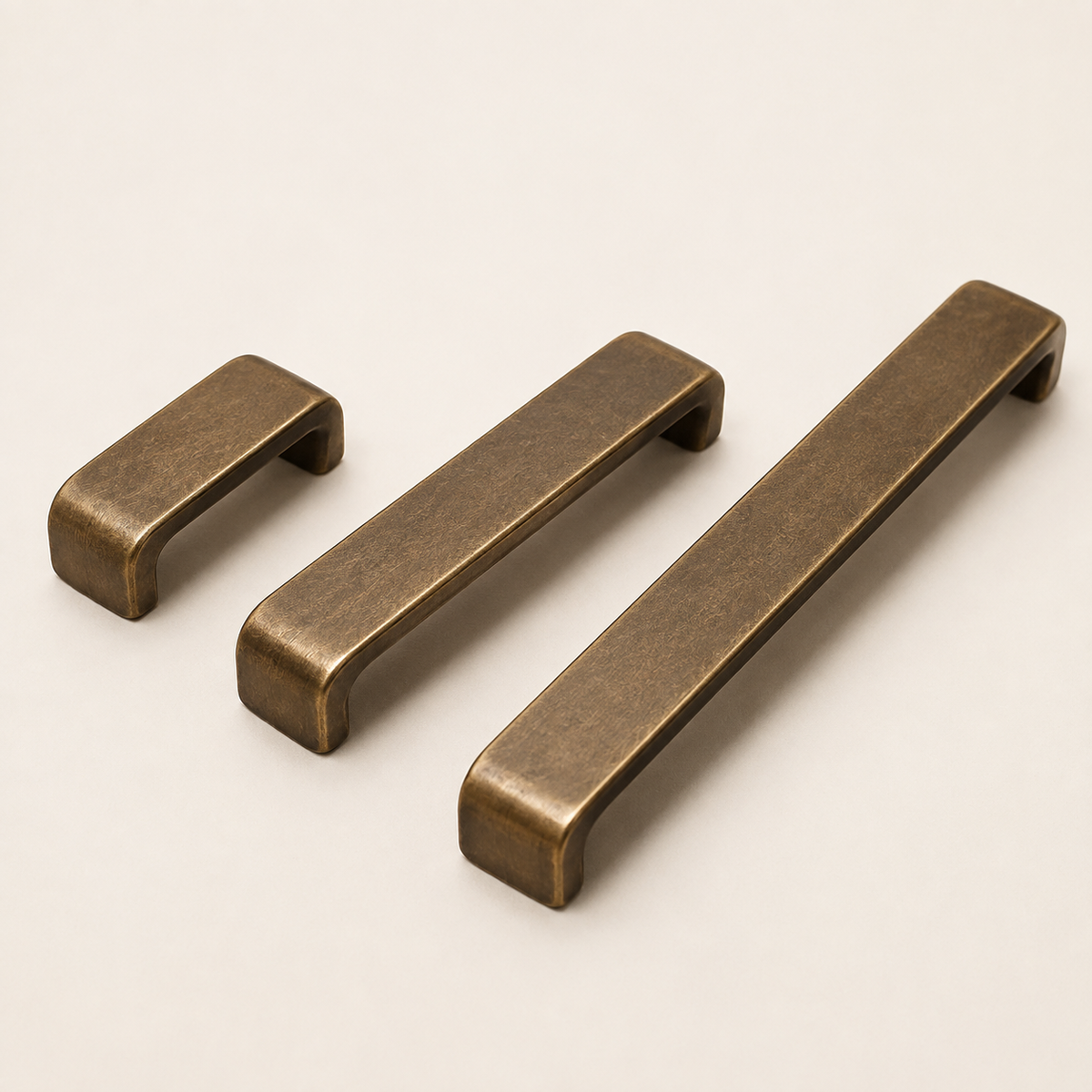 Antique bronze drawer pulls shown in three hole-centre sizes