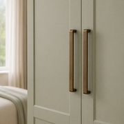 Long antique bronze drawer pulls fitted to a sage wardrobe
