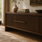 Long antique bronze drawer pull fitted to a fluted walnut sideboard