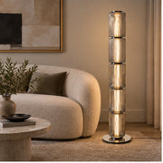 Astra floor lamp beside a curved sofa