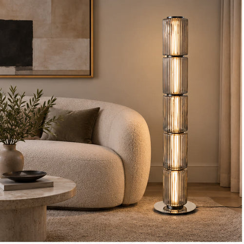 Astra floor lamp beside a curved sofa