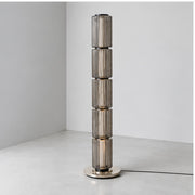Astra grey glass floor lamp in daylight, switched off