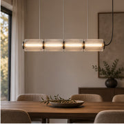 Clear-glass Astra pendant above a dining table