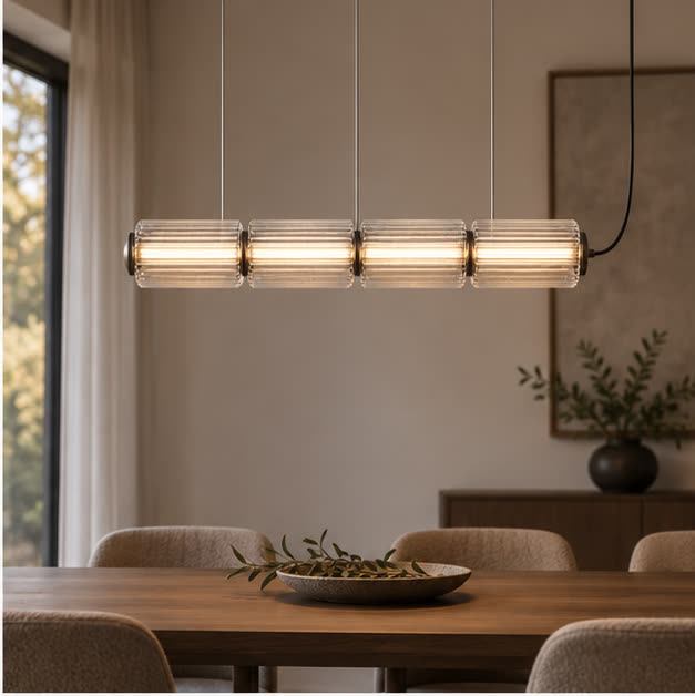 Clear-glass Astra pendant above a dining table