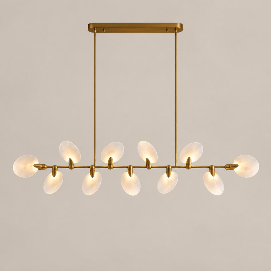 Atelier Velmora ten-light linear chandelier on a warm neutral background