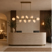 Atelier Velmora chandelier above a stone island