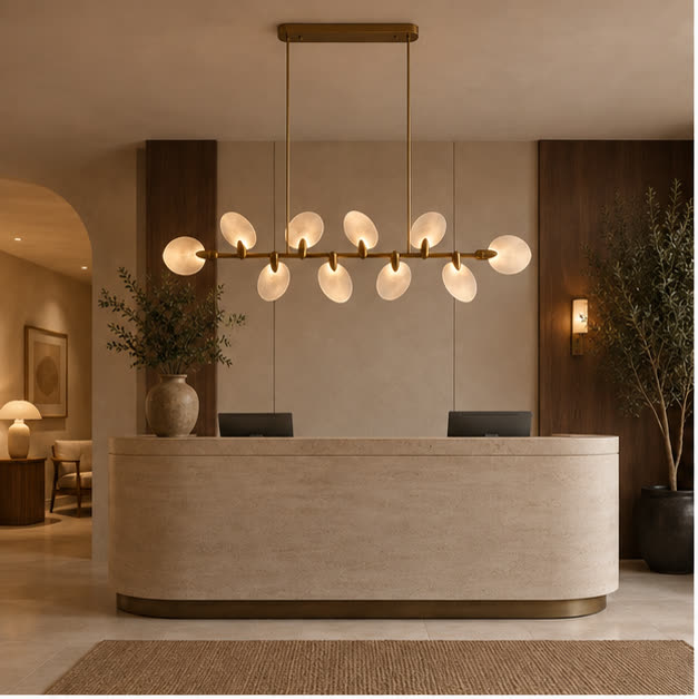 Atelier Velmora chandelier above a stone island