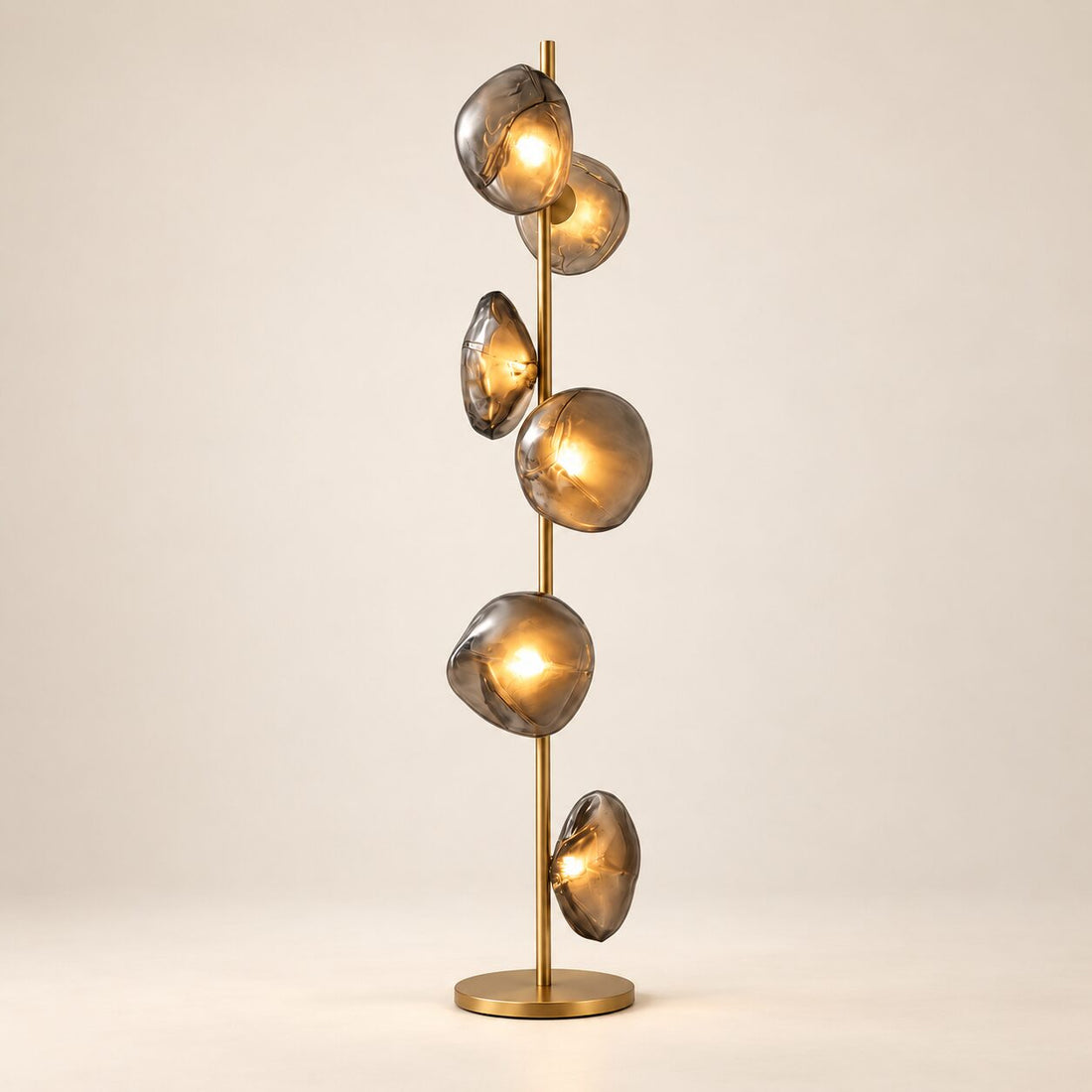 Auralis Glass Floor Lamp in Gold and Smoky Grey on a warm ivory background
