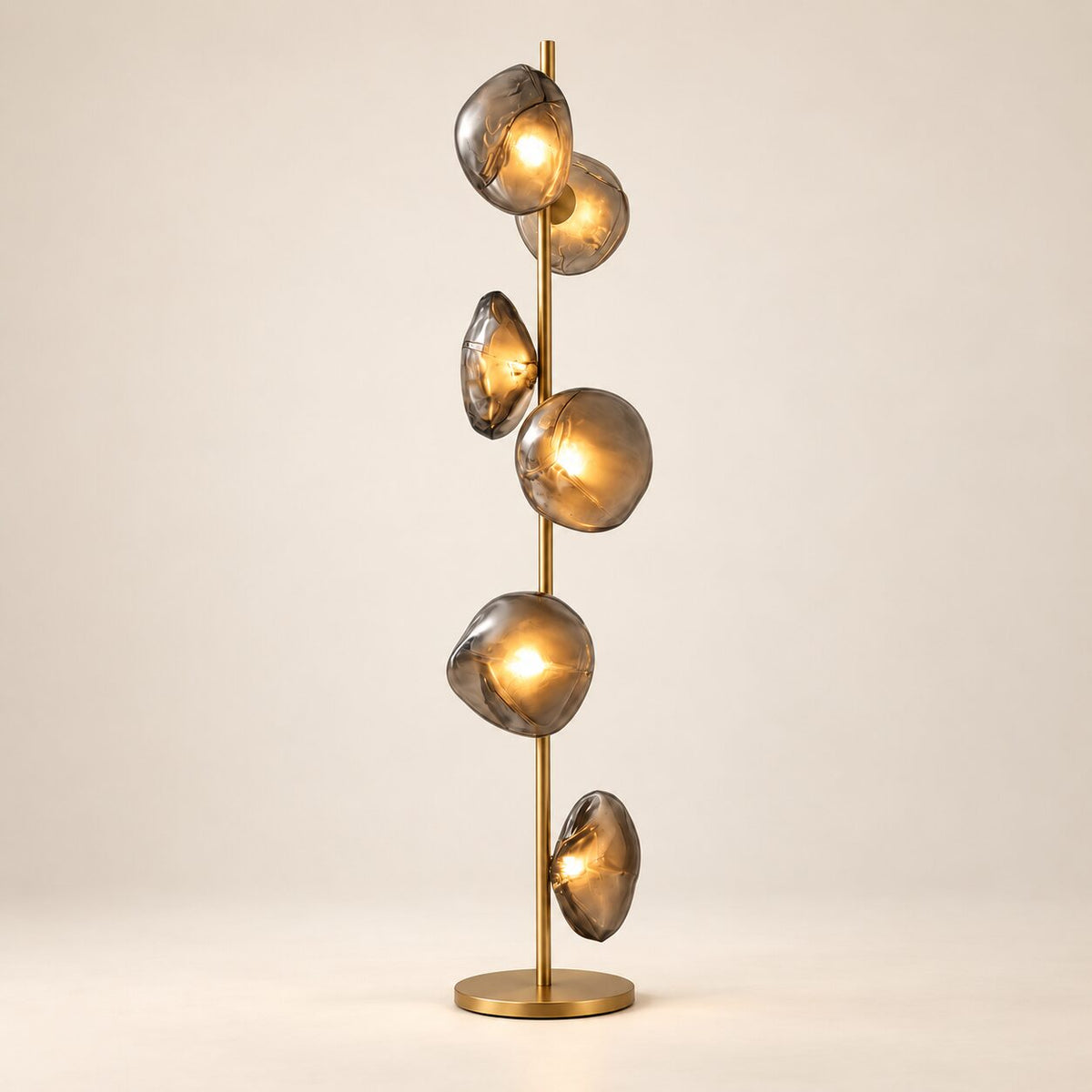 Auralis Glass Floor Lamp in Gold and Smoky Grey on a warm ivory background