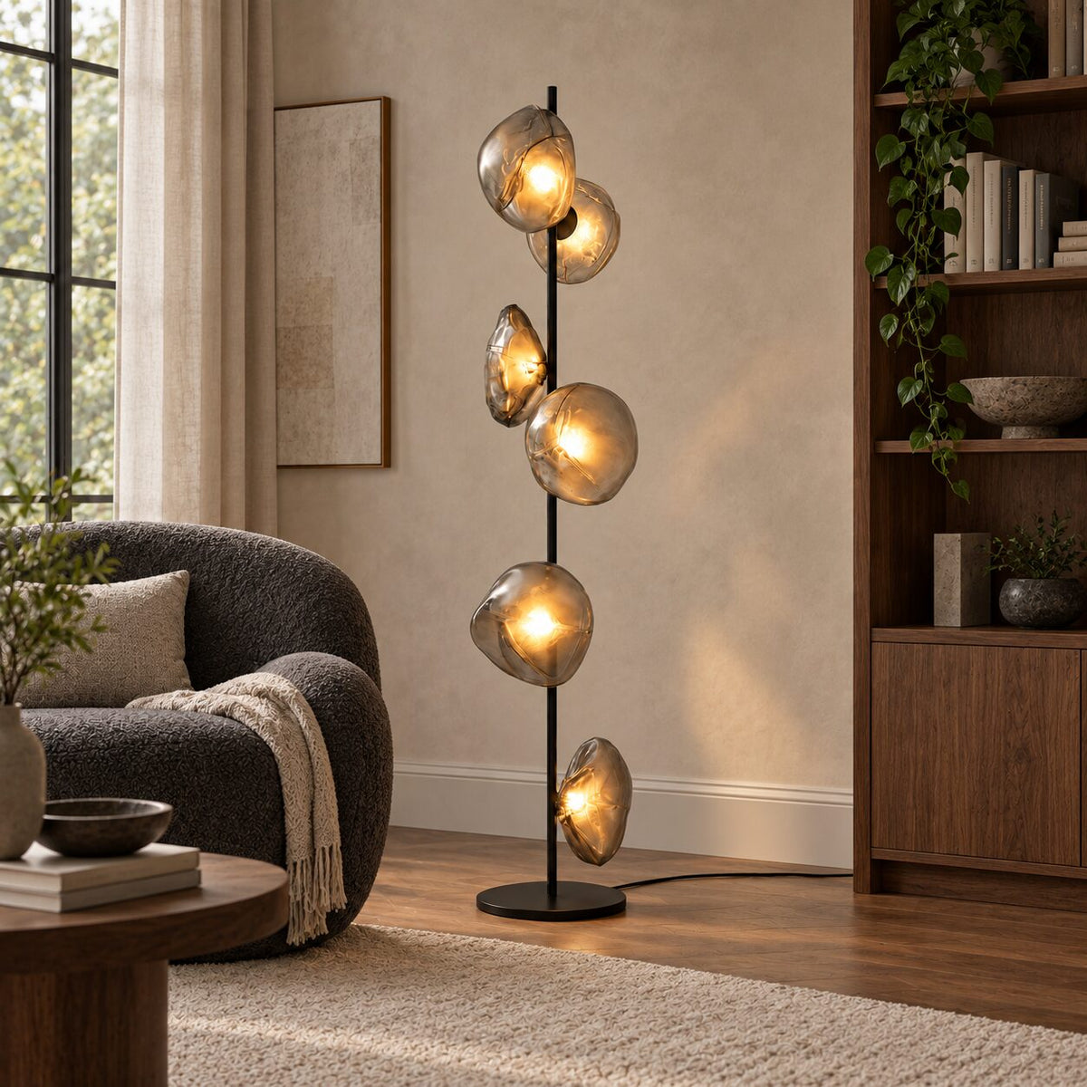 Auralis Black and Transparent Glass Floor Lamp beside a reading chair