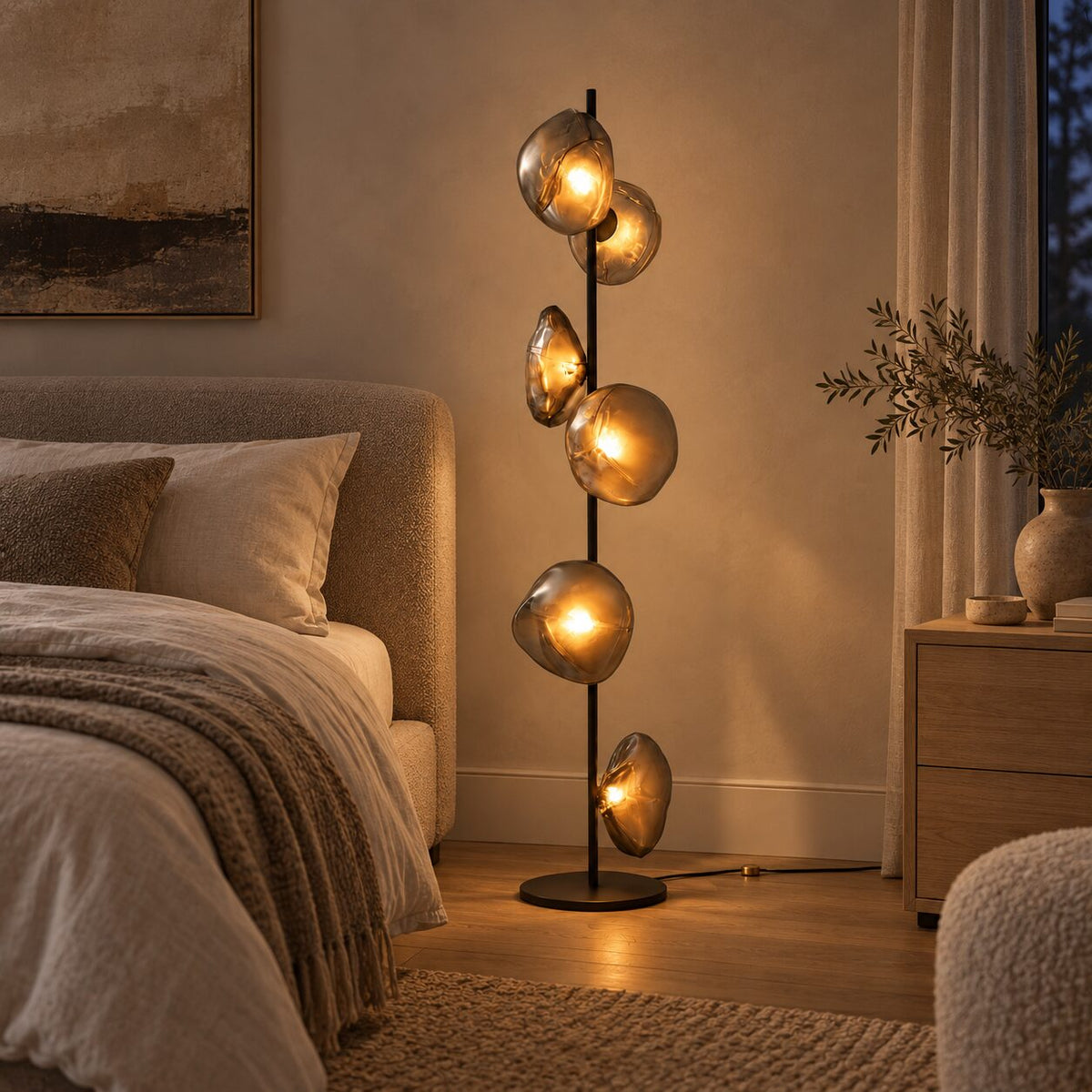 Auralis Black and Smoky Grey Glass Floor Lamp beside an upholstered bed