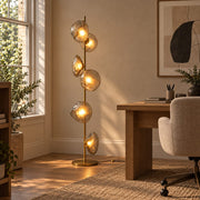 Auralis Gold and Transparent Glass Floor Lamp in a premium home office