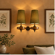 Auralis dual khaki wall lamps flanking living-room artwork