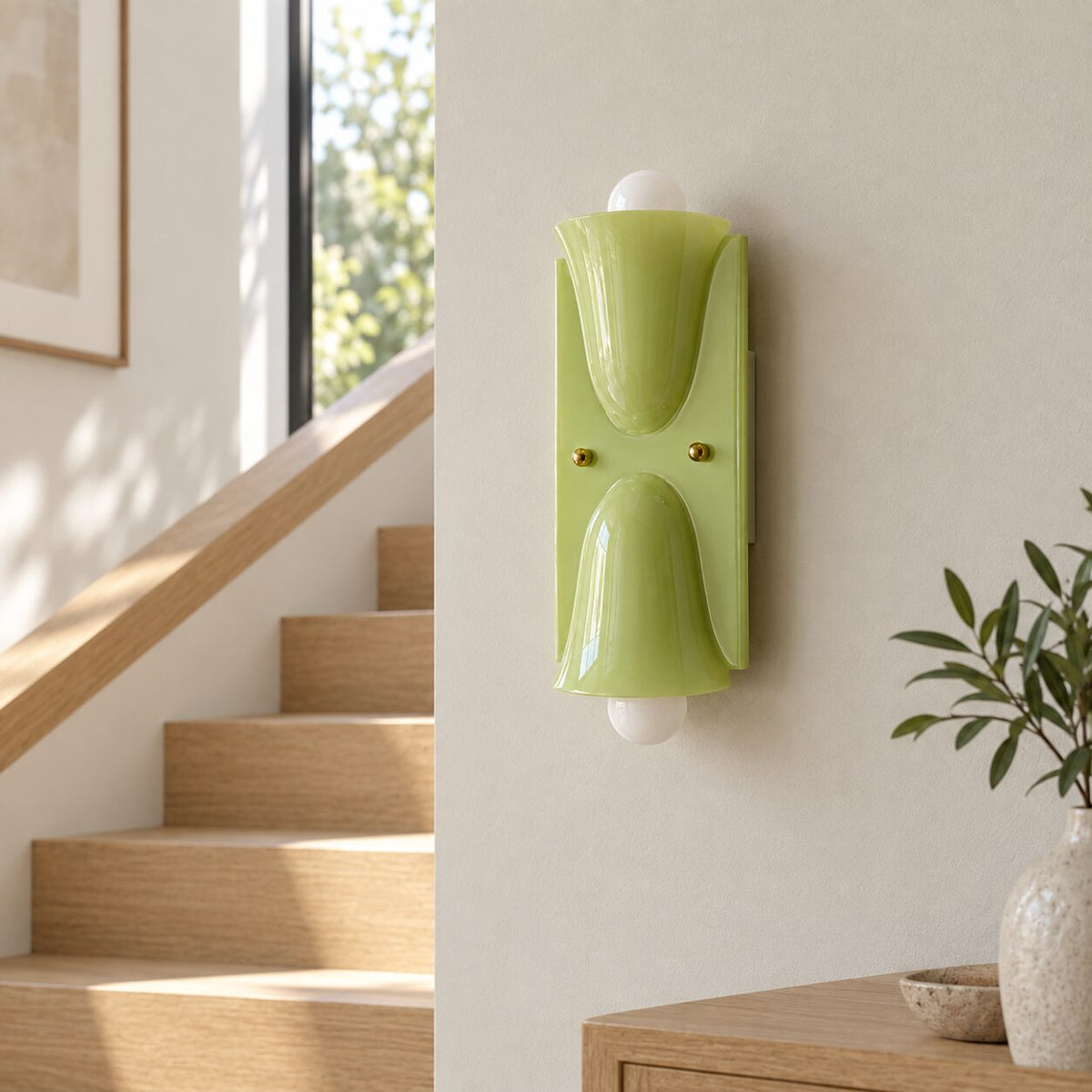 Light green Auralis wall lamp beside an oak staircase