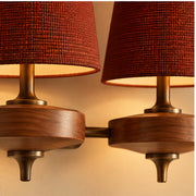 Deep red fabric weave, wood grain and bronze detail