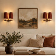 Auralis dual red wall lamps flanking living-room artwork