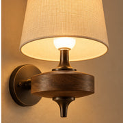 Included LED bulb glowing through the woven shade