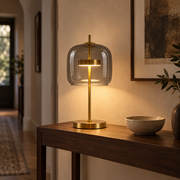 Aurelia Smoke Grey lamp casting warm light on a hallway console