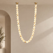 AuroMarble alabaster bead pendant in a cascading gold composition