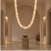 AuroMarble necklace pendant in a gallery foyer