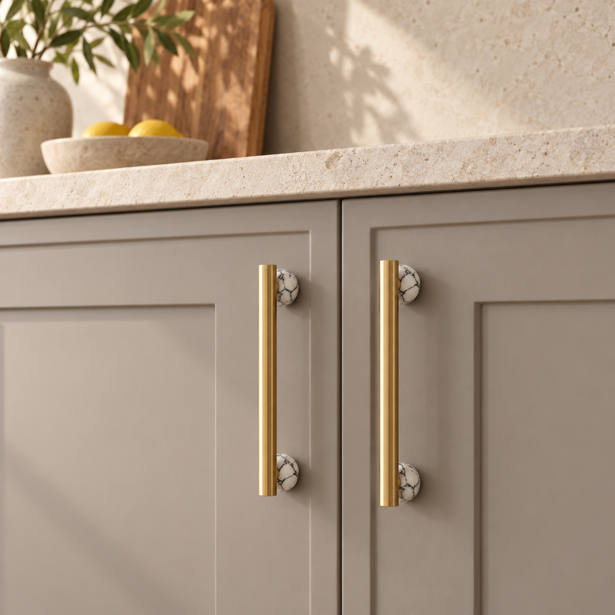 Black and white marble BlushStone pulls on taupe kitchen cabinetry