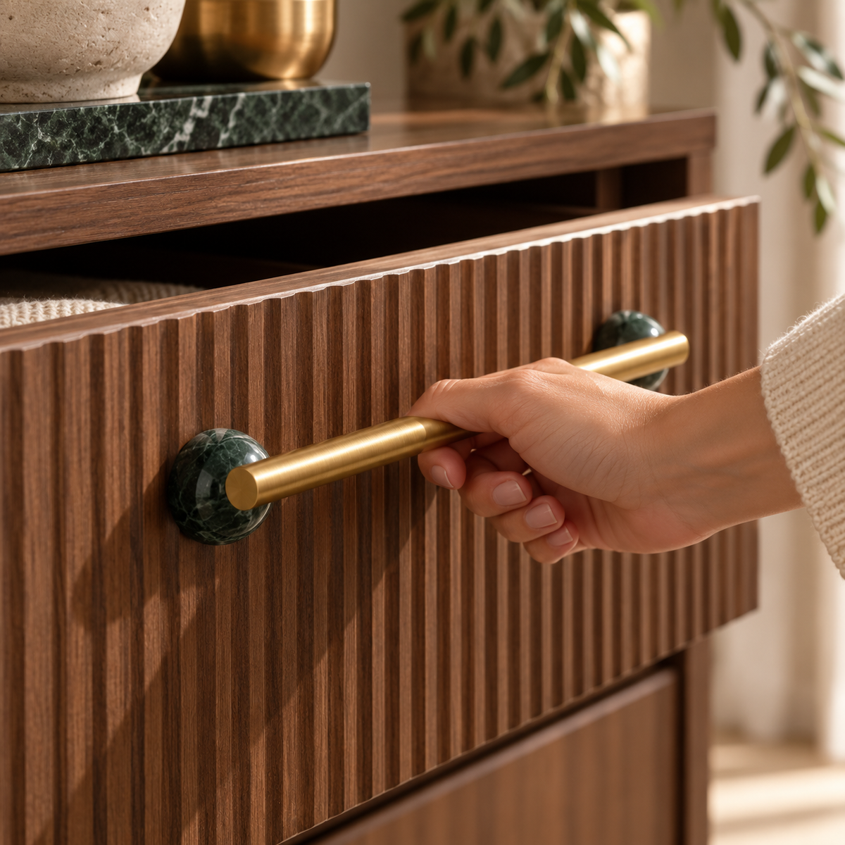 Green marble BlushStone pull opening a walnut drawer