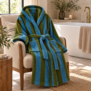 Blue and Green Bold Stripe bathrobe draped beside a bath
