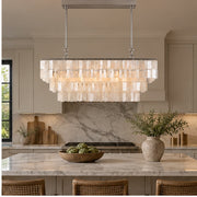 Capri linear chandelier over a marble kitchen island