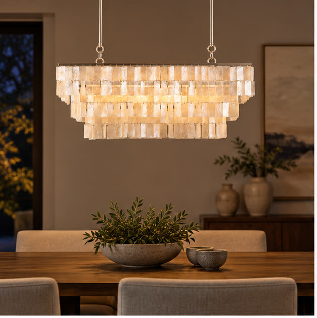 Capri linear chandelier above a dining table at evening