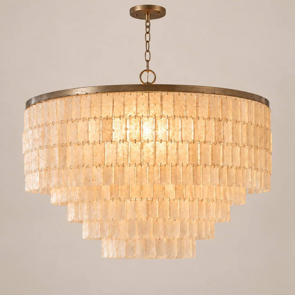 Capri round natural shell chandelier on a warm neutral background