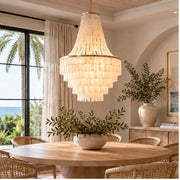 Capri tiered shell chandelier above a round dining table