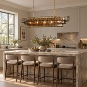 Étoile chandelier above a stone kitchen island