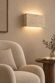 Lumo wall light casting warm light in a reading nook