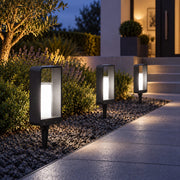 Cold white LumoEdge solar lights beside a path