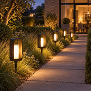 Warm LumoEdge solar lights along a garden path