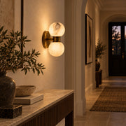 Lunara dual-globe marble wall lamp in a warm hallway
