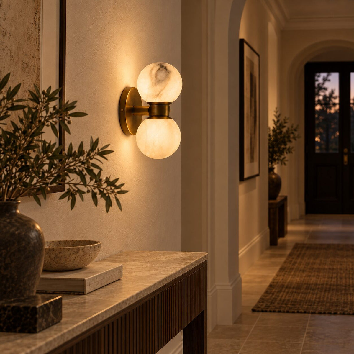 Lunara dual-globe marble wall lamp in a warm hallway