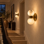 Lunara marble wall lamps along a stair landing