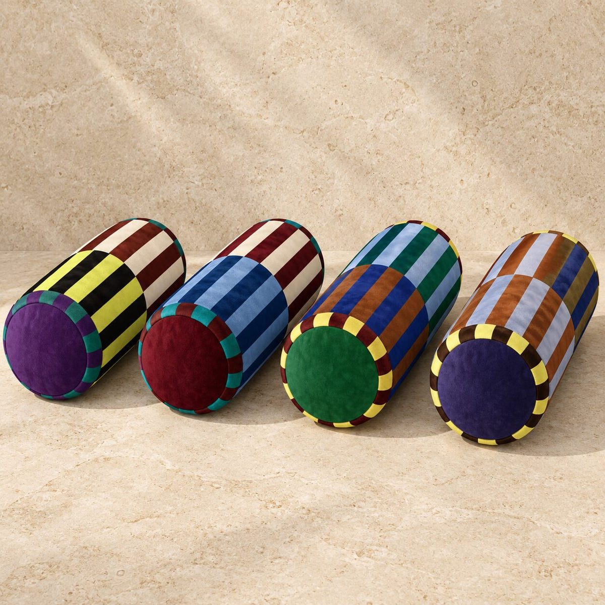 Marvella neck-roll pillow in Citrus Plum, Sapphire Wine, Emerald Rust and Mocha Navy colourways