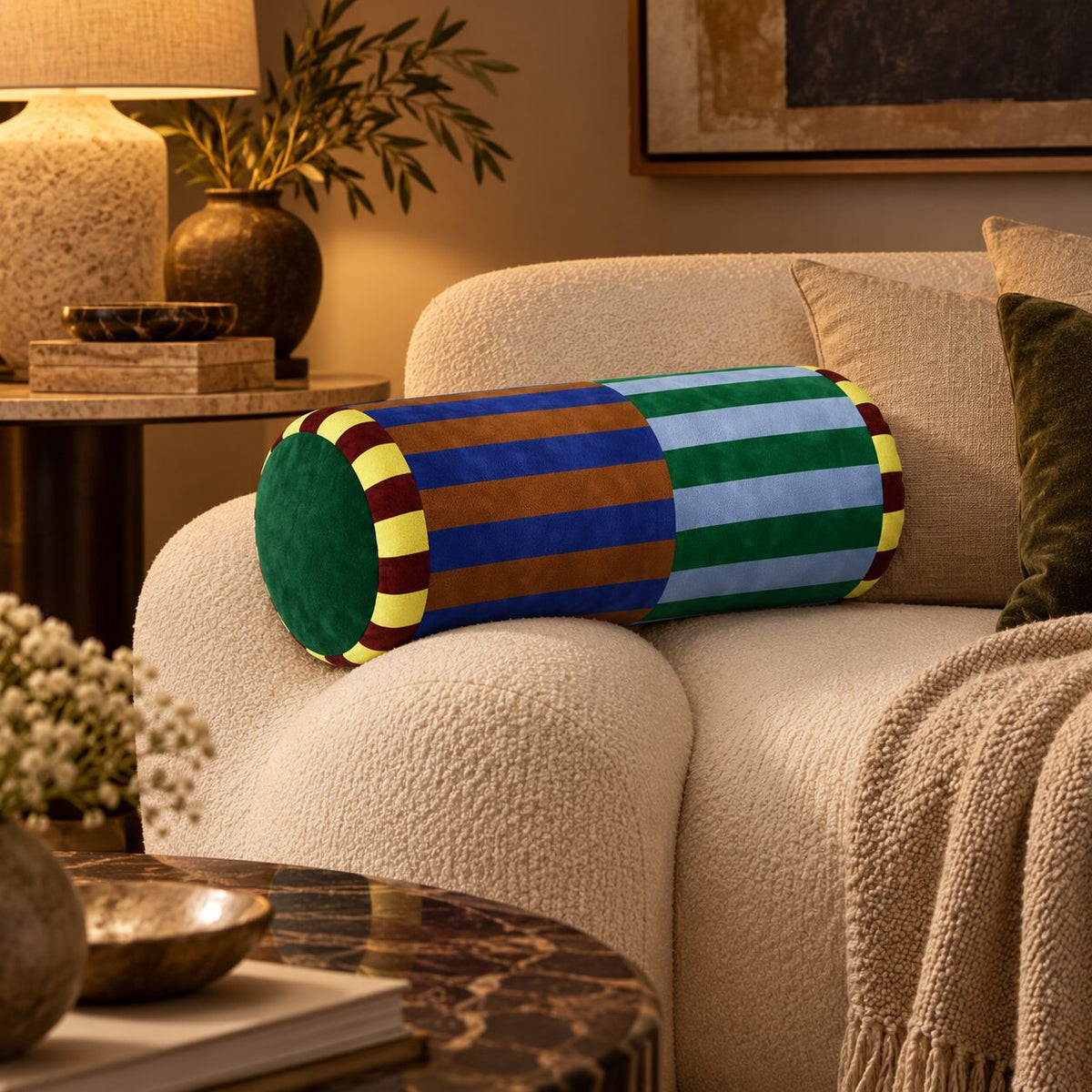 Marvella Luxe Velvet Neck Roll Pillow styled on a cream sofa