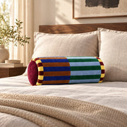 Marvella cylindrical velvet pillow styled across a premium bed