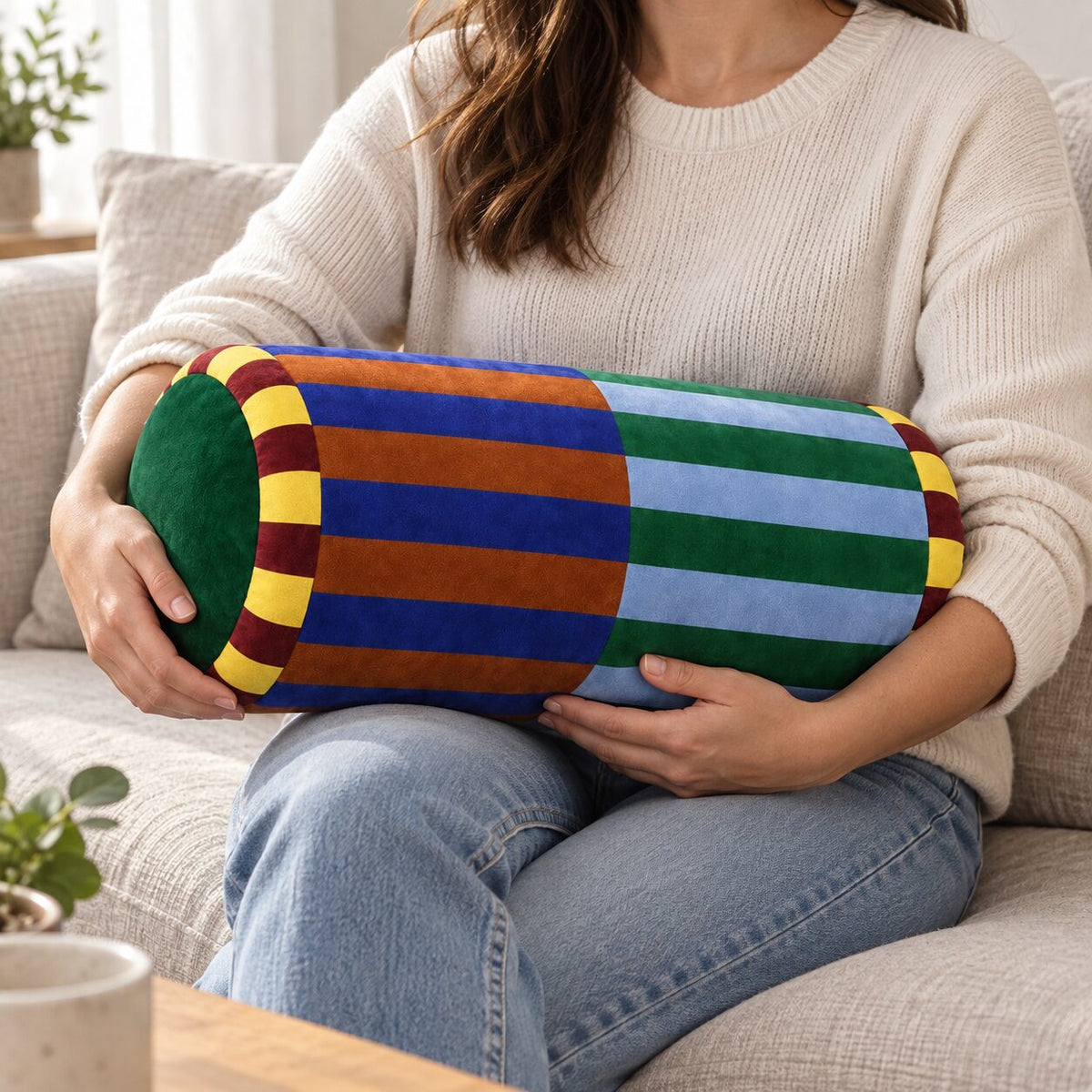 Marvella 20 by 45 centimetre neck-roll pillow shown at true sofa scale