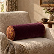 Marvella Citrus Plum neck-roll pillow in a warm reading corner