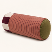 Sovana Rose Plum velvet neck-roll pillow from a three-quarter angle