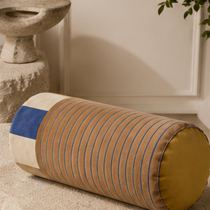 Sovana velvet neck-roll pillow in Sand Sky in a calm bedroom