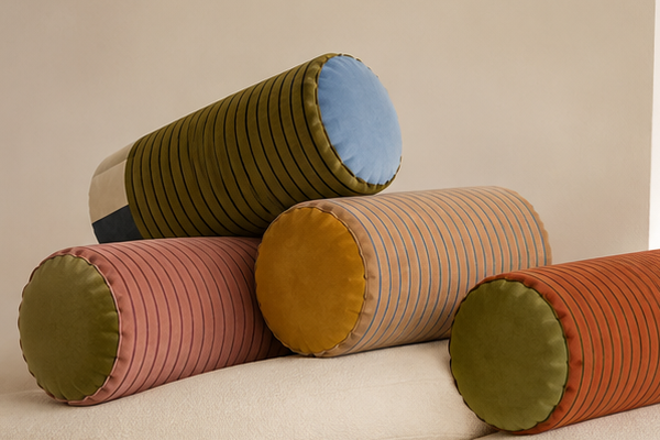 All four Sovana velvet neck-roll pillow colourways